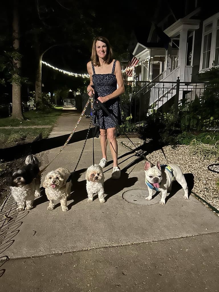 Lauren walking four happy dogs in her Chicago neighborhood